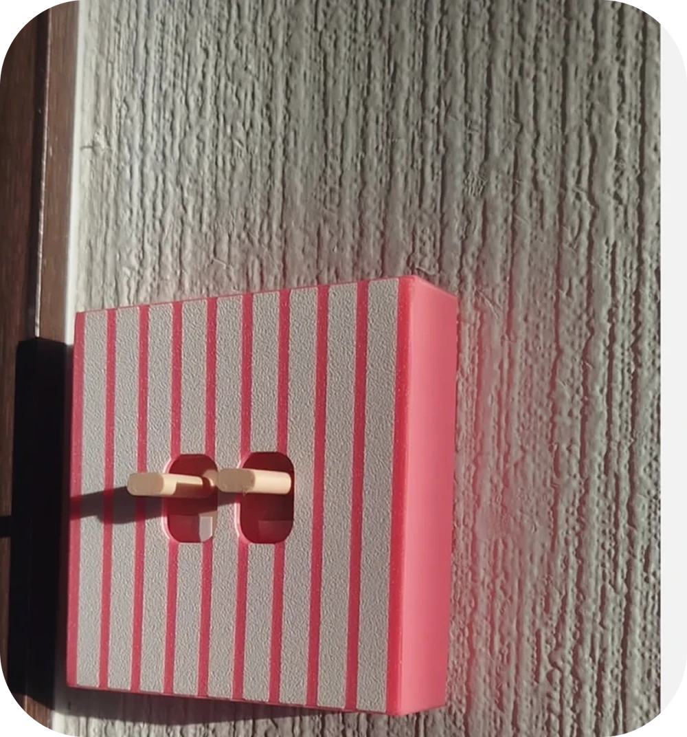 Pink striped double-switch cover in a customer’s home