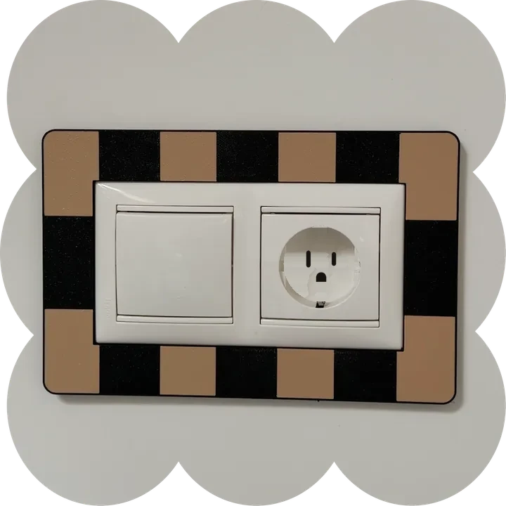Checkered frame around a switch and outlet